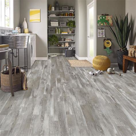  Calabash Oak has a natural textured finish that compliments the light beige-gray planks. . Lowe flooring